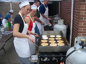 Volunteers cooking pancakes