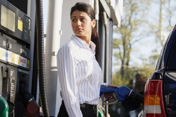 Woman pumping gas