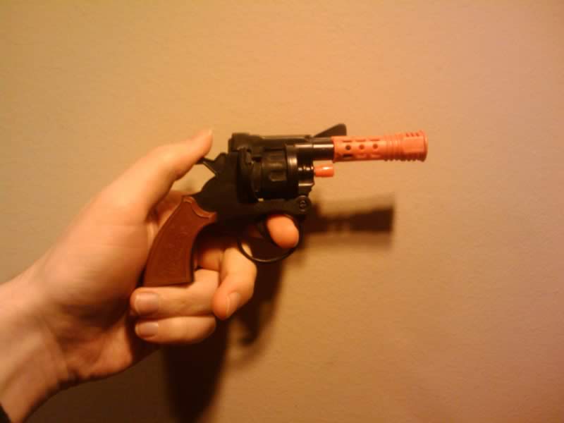 modern cap gun, bright orange plastic, toy gun