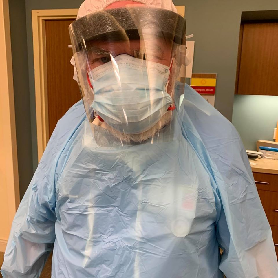 Dr. Mark McKeigue, D.O., prepares to see a COVID-19 patient