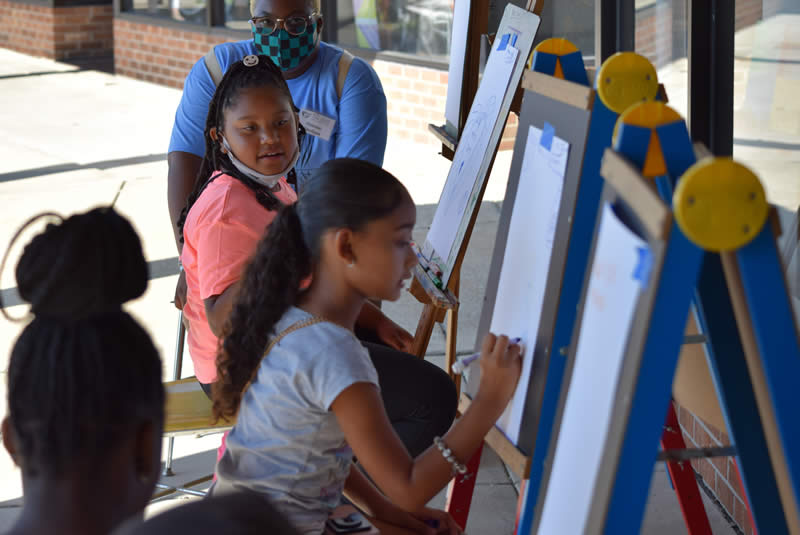 Children, always a blessing, draw Saturday at the Park Forest Art Fair.