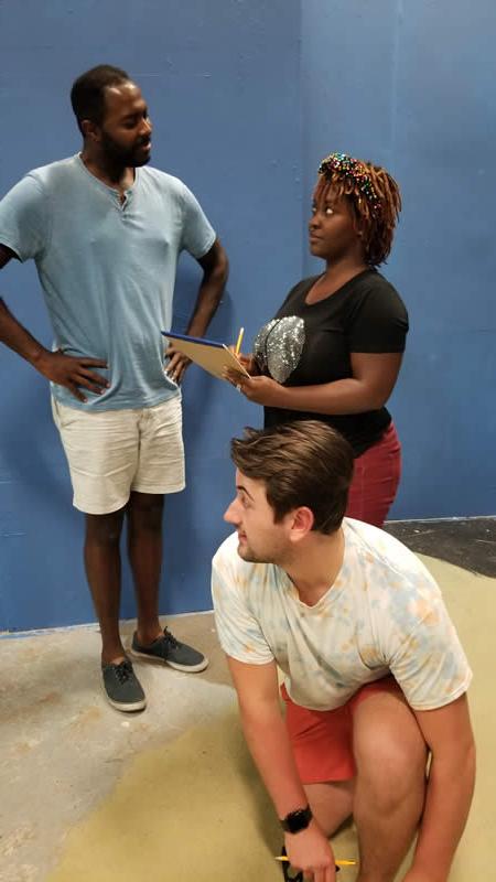 Gatch (Sean Michael Williams) talks to Miss Jones (Dominiqe Adams) while J. Pierrepont Finch (Luke Nowakowski) listens in this rehearsal for “How to Succeed in Business without Really Trying” at The Drama Group, running October 1-10, 2021.