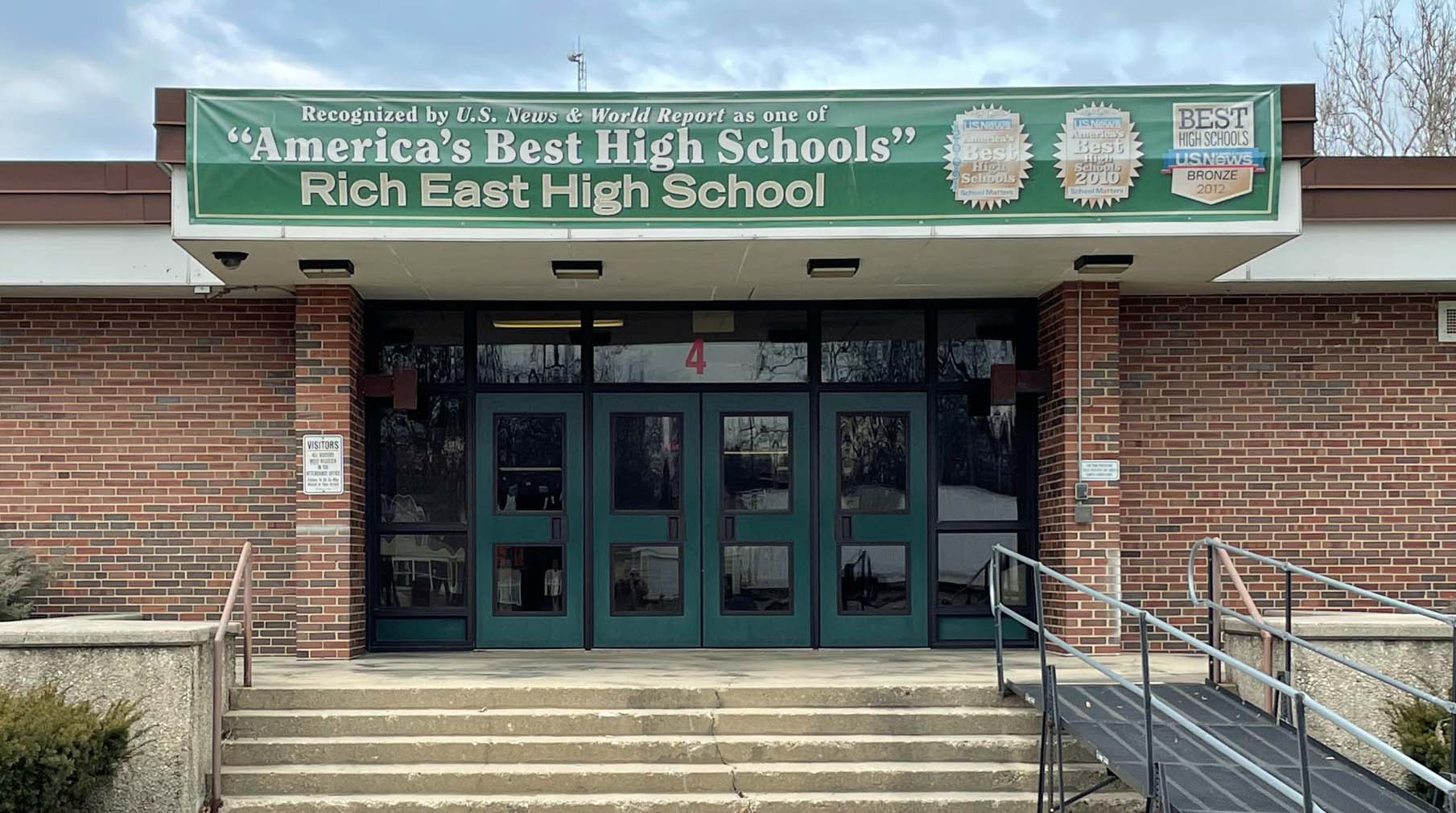 entrance to high school with banner above the doors