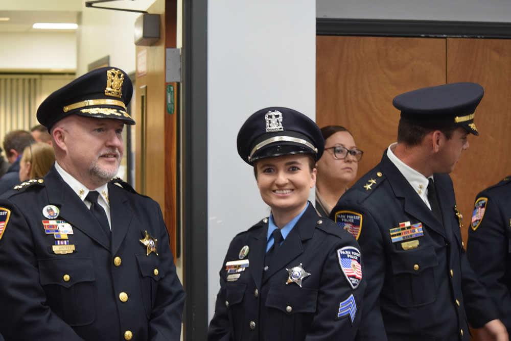 Chief of Police Paul Winfrey, Sergeant Meghan Vold, and Deputy Chief John DeCeault with colleagues, friends, and family members.