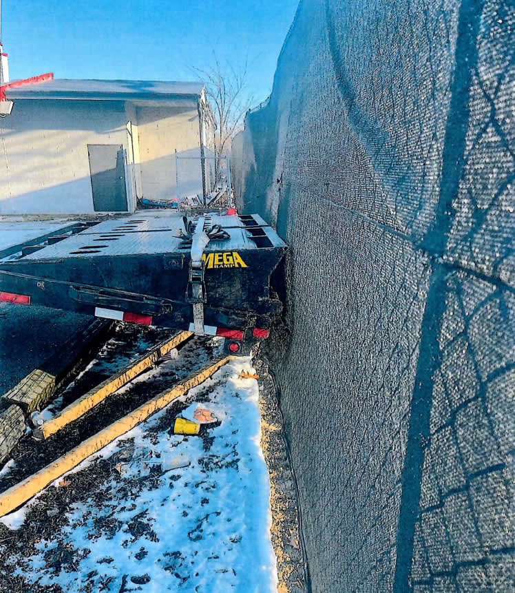 Another truck parked up against the fence at Ash Street Cooperative, this one in March.