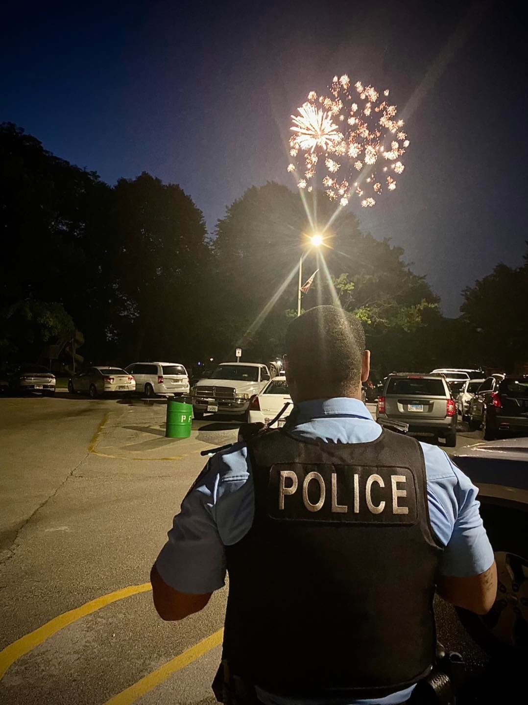 An officer enjoys fireworks on July 4 in Park Forest
