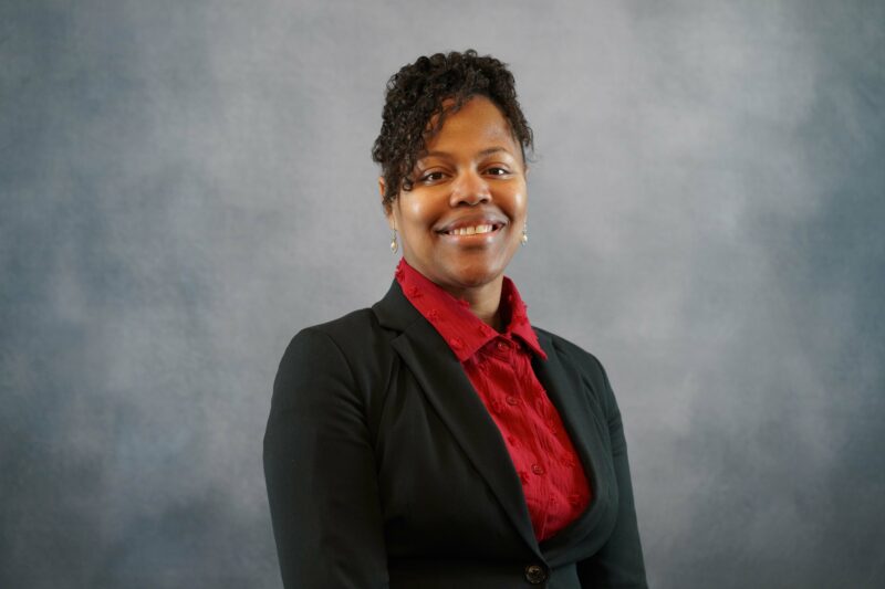 portrait of woman against grey background