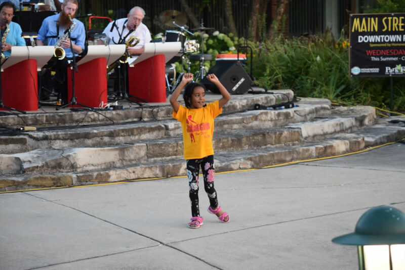 Young girl dancing at Main Street Nights