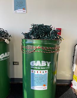 Green bin filled with Christmas lights