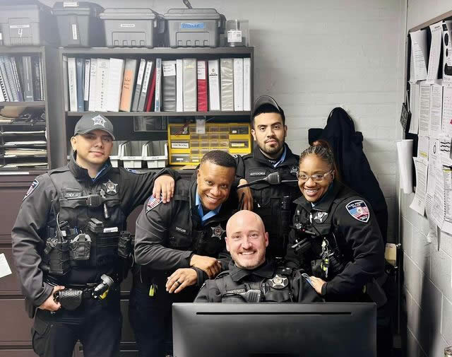 Detective Sergeant Rimovsky seated among colleagues