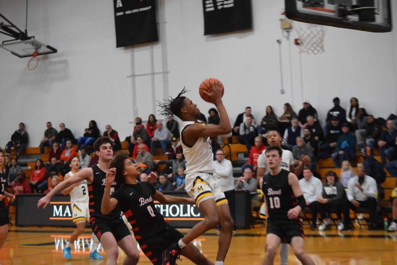 Quentin Jones puts up a successful shot against Benet