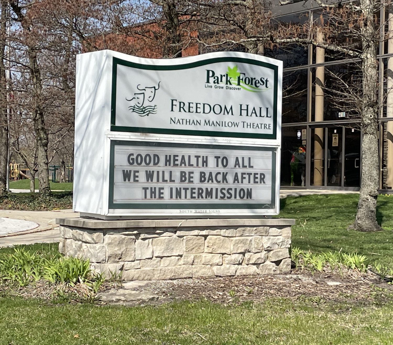 Marquee sign in front of brick building