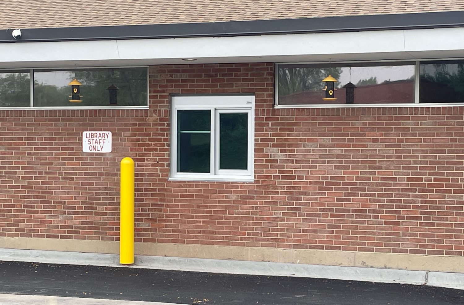 red brick building with a drive-up window