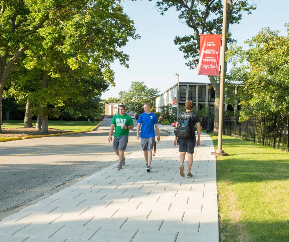 Students walk between classes at Carthage College, summer research