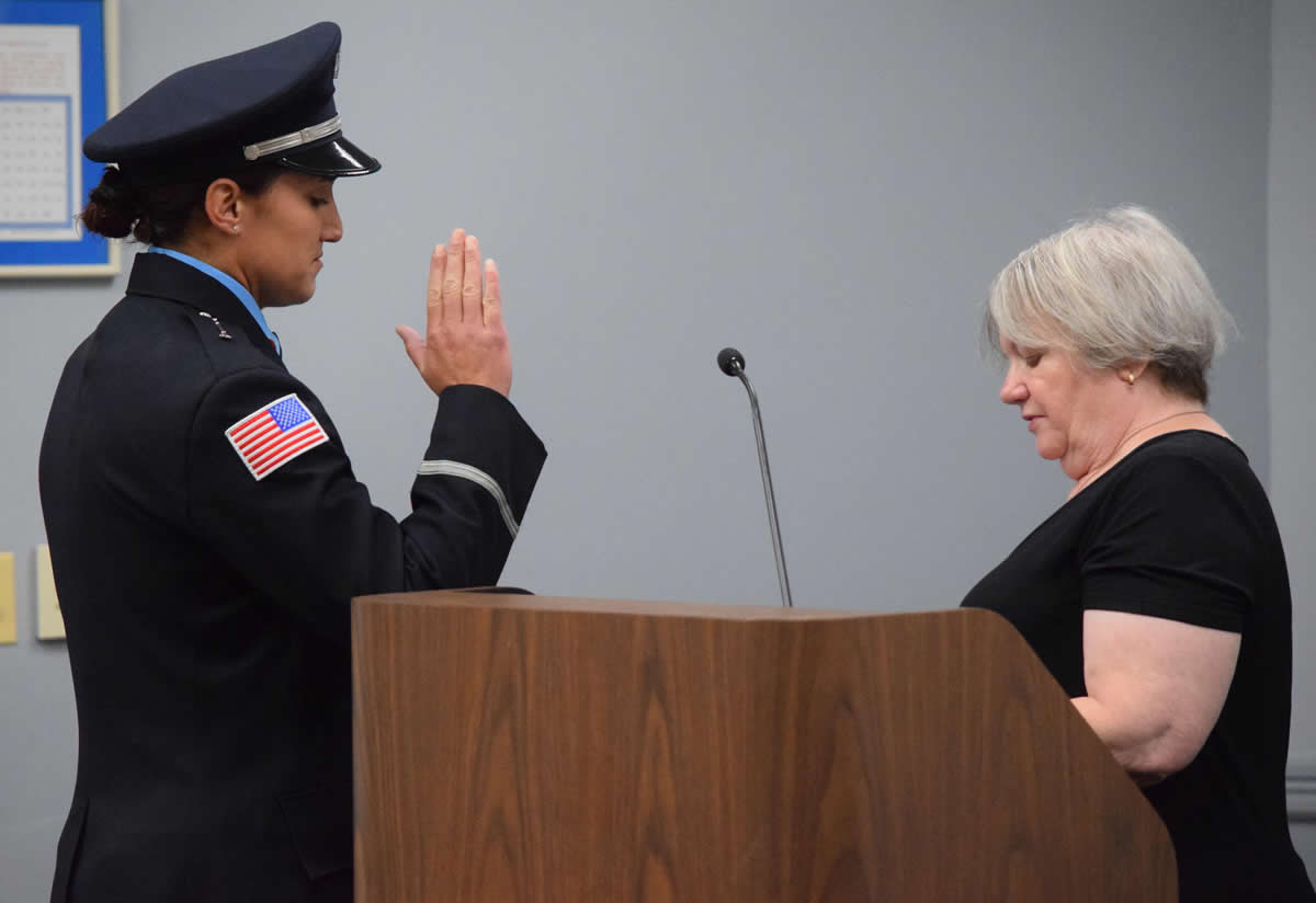 Village Clerk Shelia McGann administers the oath of office to Lt. Michelle Paradise.