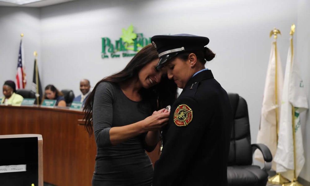 Lieutenant Michelle Paradise's wife Tristan pins on her badge.