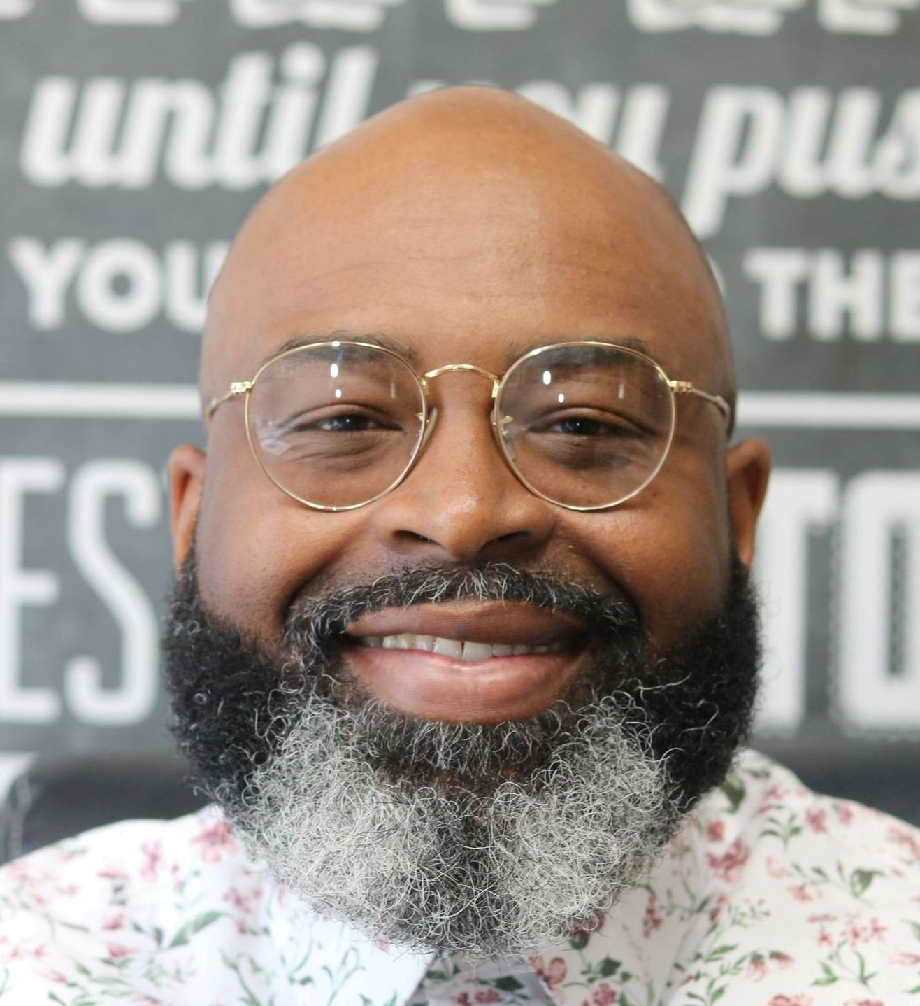 headshot of a man with beard and glasses