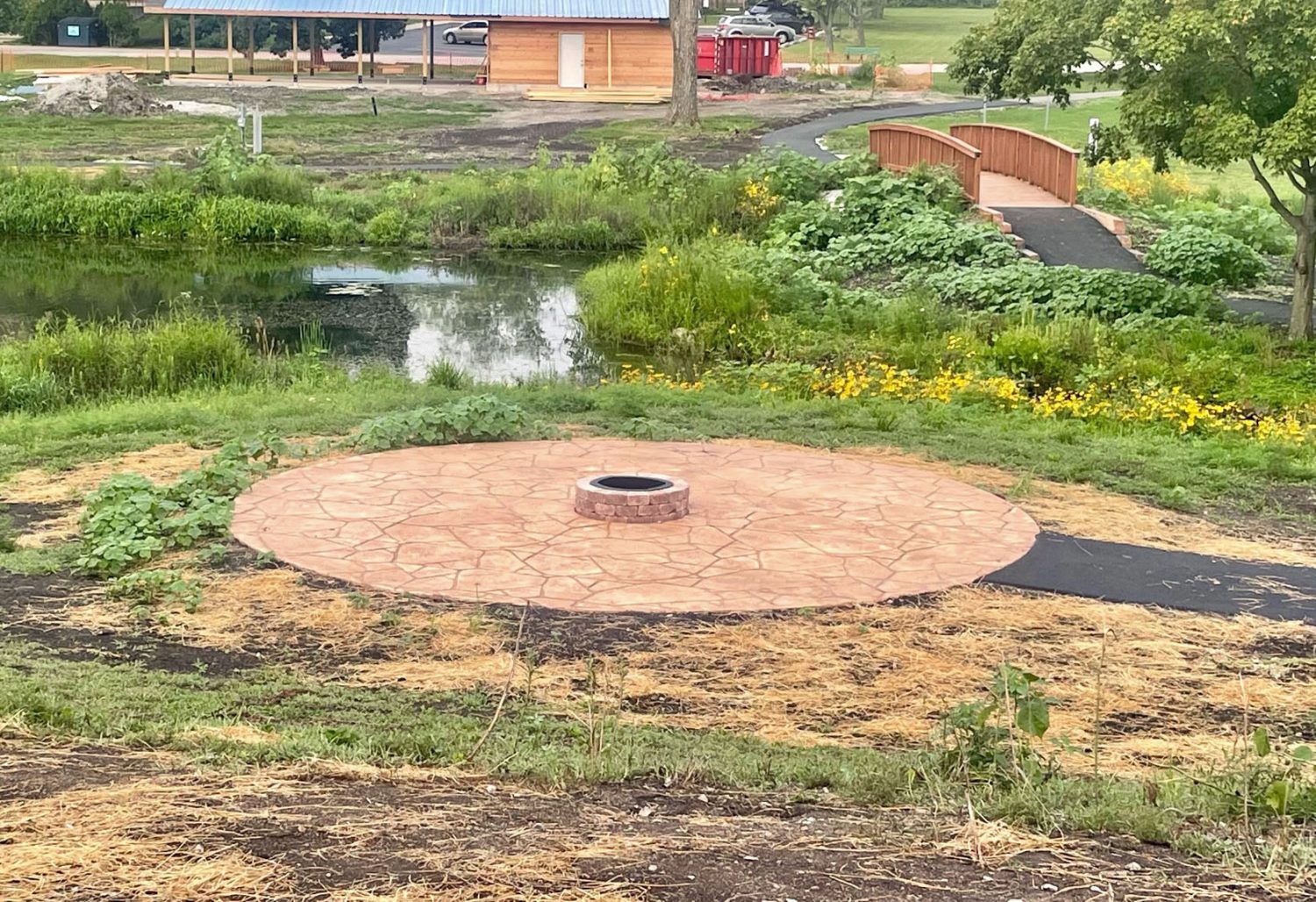 a circular stone platform with a fire pit in the middle