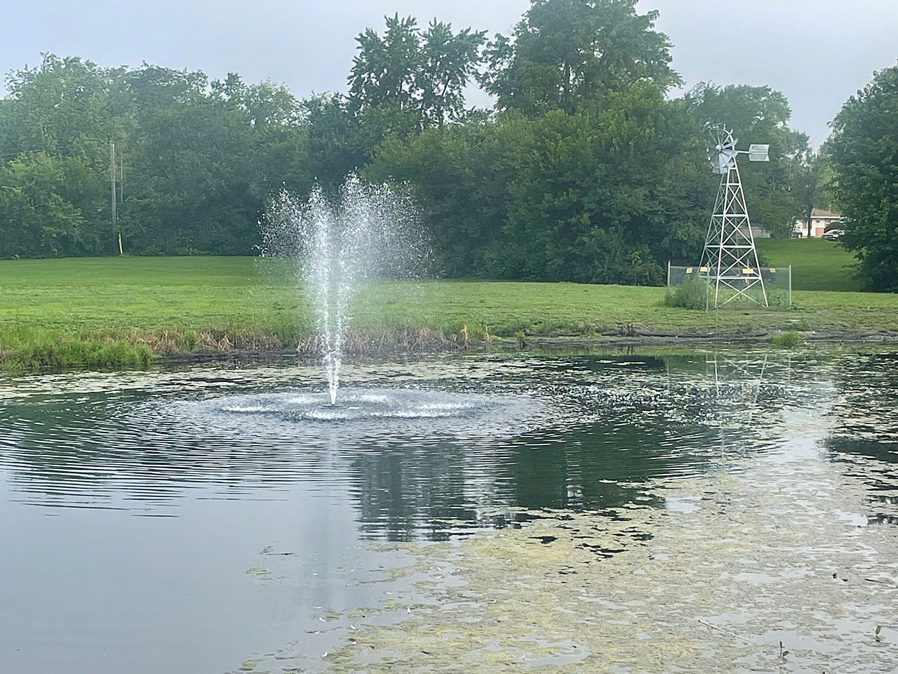 pond with a fountain in the middle