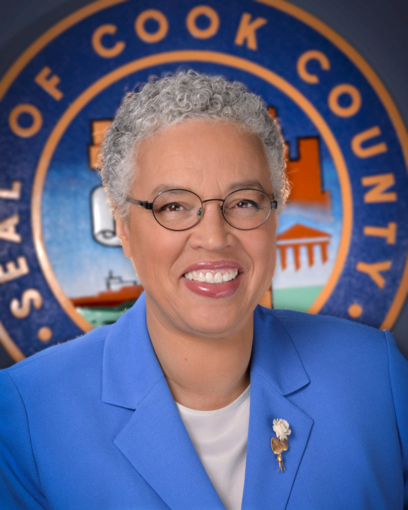 photograph of a woman in front of a government official seal