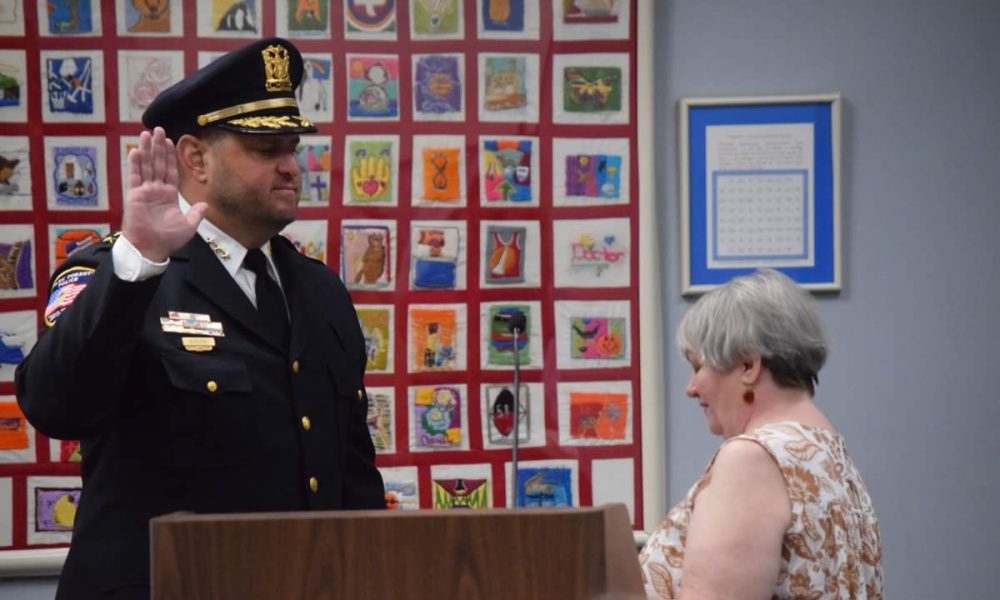 Village Clerk Shelia McGann administers the oath of office to Brian Rzyski as Chief of Police. (Photo: Gary Kopycinski)