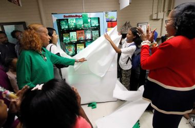 Administrators and students unveil a Book Vending Machine at Illinois School.