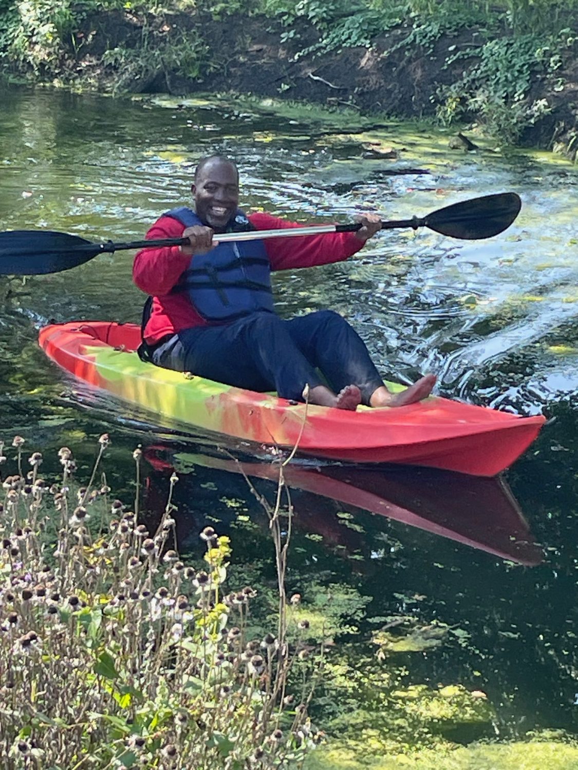 Mayor Woods sitting in a kayak holding up an oar as Somonauk Park opens.