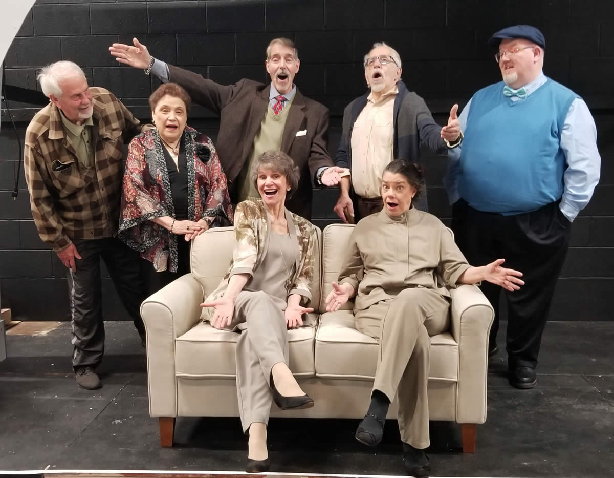 (L to R) Tim (Tim Bray), Ann (Rose Crockett), Reggie (Mike Cabsinger), Wilf (Ken Hawkley) and Bobby (Michael Behrens) stand behind Jean (Liliana Mitchell) and Cissy (Alicia Cuccia) in this cast photo. The comedy Quartet runs at The Drama Group from April 12 to 21.