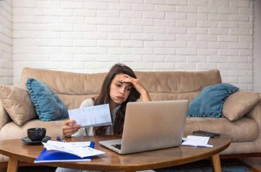 woman stressed over bills, utility bill